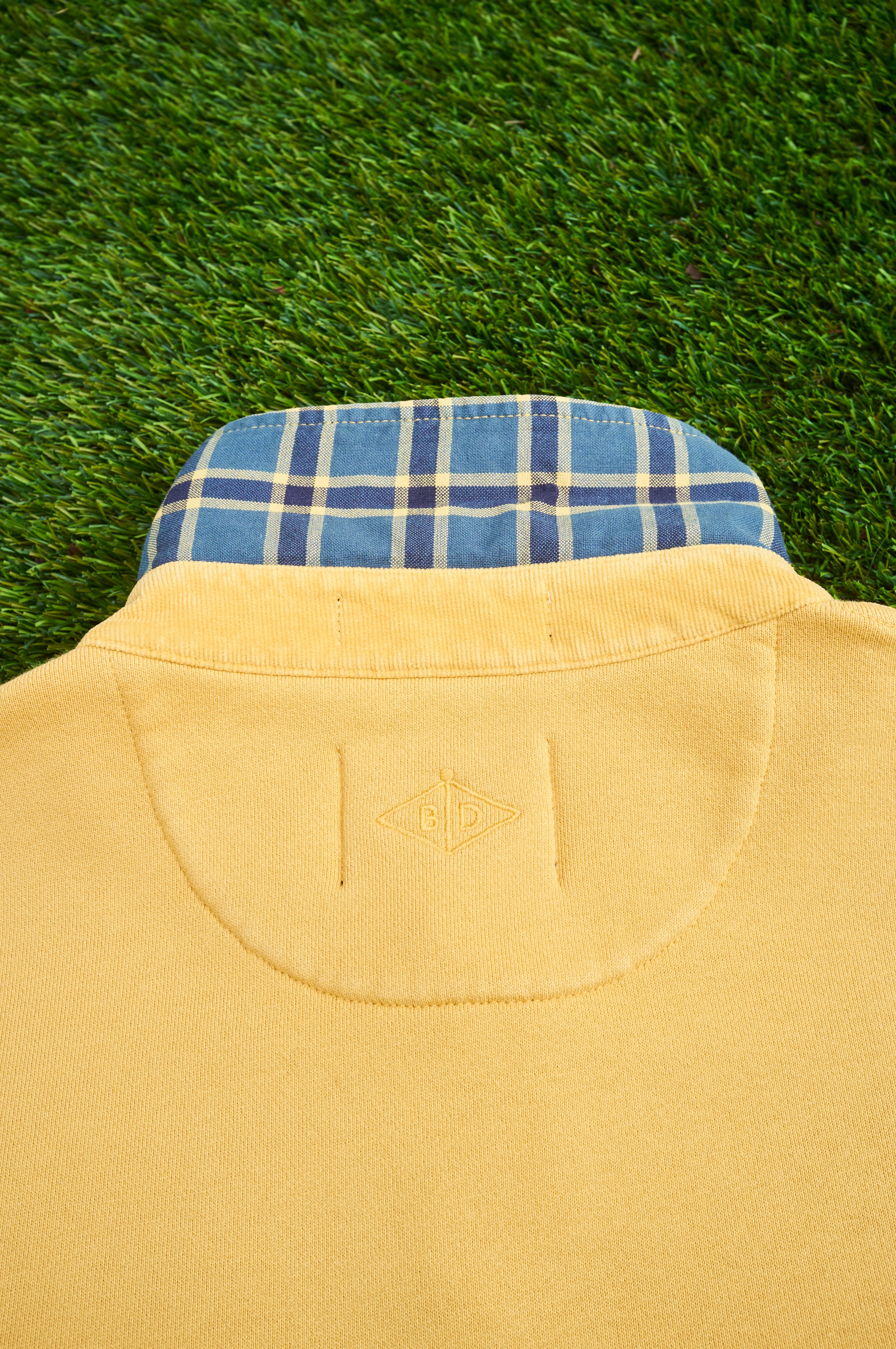 The Fife golf polo in cheese toastie yellow. back with collar